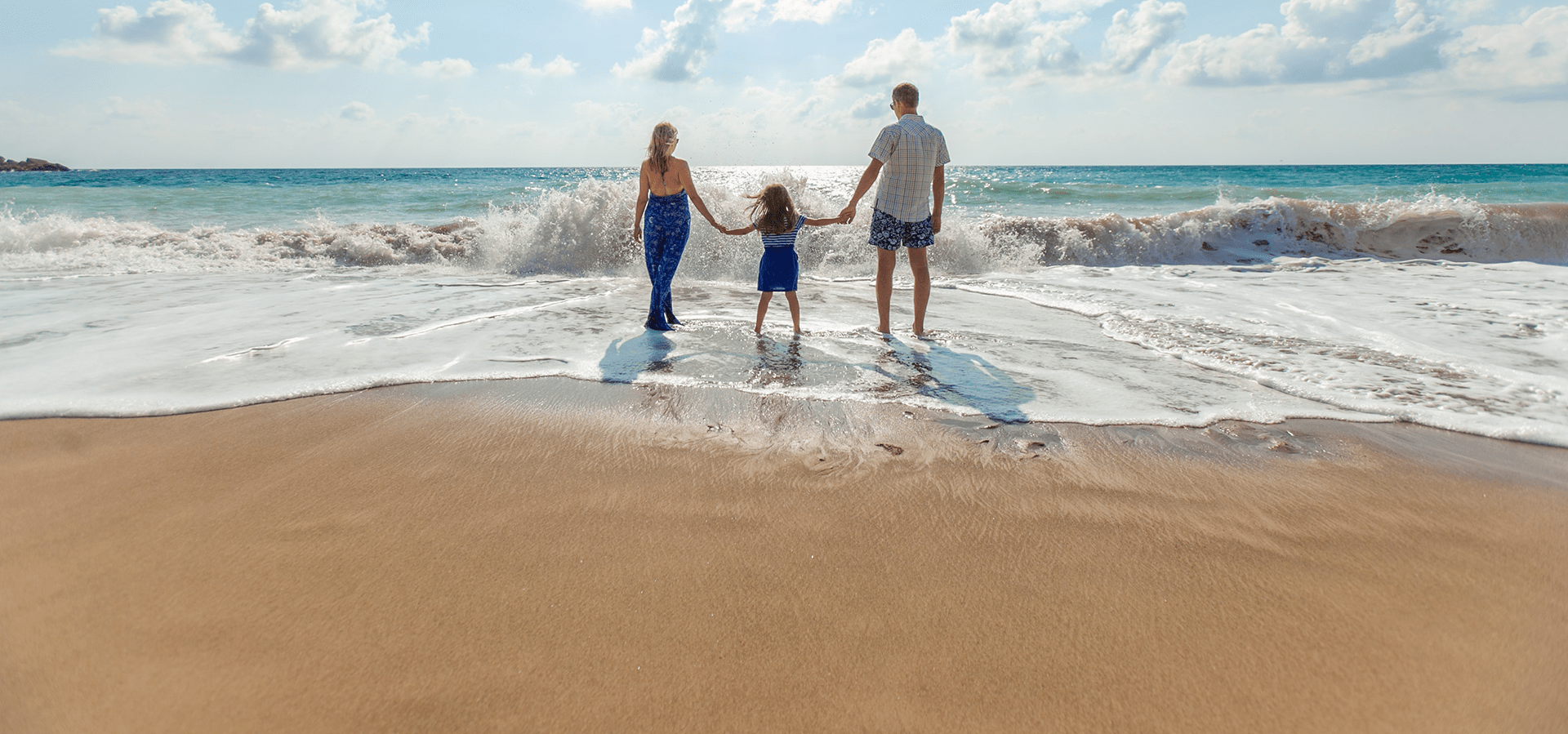Family walking in surf